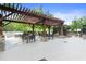 Relaxing outdoor patio with a pergola, comfortable seating, stone accents, and lush landscaping at 3300 Windy Ridge Se Pkwy # 1107, Atlanta, GA 30339