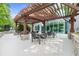 Outdoor patio area with pergola, stone accents, and comfortable seating arrangements at 3300 Windy Ridge Se Pkwy # 1107, Atlanta, GA 30339