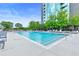 Resort-style pool with lounge chairs surrounded by lush greenery at 3300 Windy Ridge Se Pkwy # 1107, Atlanta, GA 30339