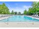 Outdoor pool area with lounge chairs and lush landscaping, perfect for relaxing and enjoying the sun at 3300 Windy Ridge Se Pkwy # 1107, Atlanta, GA 30339