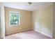 Carpeted bedroom with a window and neutral walls at 3963 Ferncliff Rd, Snellville, GA 30039
