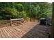 Large wooden deck overlooking a private backyard, equipped with a grill, perfect for outdoor entertaining at 3963 Ferncliff Rd, Snellville, GA 30039