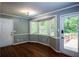 Sunlit dining area featuring wood floors, ample natural light, and access to the outdoor deck at 3963 Ferncliff Rd, Snellville, GA 30039