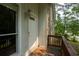Cozy covered entryway, complete with wooden deck, exterior lighting, and stone accent wall at 3963 Ferncliff Rd, Snellville, GA 30039