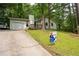 Inviting single Gathering home featuring a charming front porch and lush, mature landscaping at 3963 Ferncliff Rd, Snellville, GA 30039