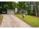 Inviting single Gathering home featuring a charming front porch and lush, mature landscaping at 3963 Ferncliff Rd, Snellville, GA 30039