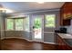 Eat-in kitchen with wood cabinets, black countertops, and a view of the outdoor deck at 3963 Ferncliff Rd, Snellville, GA 30039