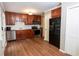 Updated kitchen with stainless steel appliances, wood cabinets, and wood-look floors at 3963 Ferncliff Rd, Snellville, GA 30039