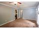 A spacious living room featuring neutral walls, carpet, and a glimpse of the kitchen at 3963 Ferncliff Rd, Snellville, GA 30039