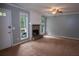 Cozy living room featuring a stone fireplace and neutral carpeting at 3963 Ferncliff Rd, Snellville, GA 30039