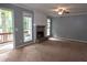 A bright living room showcasing a cozy fireplace, neutral walls, and access to the outdoor deck at 3963 Ferncliff Rd, Snellville, GA 30039