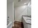 Bathroom featuring a tiled shower, tub and granite countertop with dual sinks at 1958 Asher Ln # 50, Conyers, GA 30013