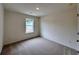 This bedroom is well-lit with neutral carpeting and one window at 1958 Asher Ln # 50, Conyers, GA 30013