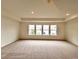 Spacious bedroom with plush carpeting, recessed lighting, and four large windows at 1958 Asher Ln # 50, Conyers, GA 30013