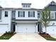 Charming townhome featuring a white brick facade and a two-car garage at 1958 Asher Ln # 50, Conyers, GA 30013