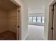 Hallway view into a large bedroom with a bank of windows and a walk-in closet at 1958 Asher Ln # 50, Conyers, GA 30013