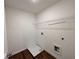 Neat laundry room boasts wood-look floors, white walls, and wire shelving for optimal organization at 1958 Asher Ln # 50, Conyers, GA 30013