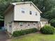 Side view of home featuring stone accents, garage, and entrance with deck at 2523 Bronco Trl, Duluth, GA 30096