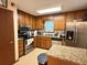 Cozy kitchen with stainless steel appliances, granite countertops, and oak cabinetry at 2523 Bronco Trl, Duluth, GA 30096