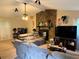 Spacious living room with a cozy stone fireplace, large windows, and neutral tones at 2523 Bronco Trl, Duluth, GA 30096