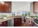 Modern kitchen featuring granite countertops, stainless steel appliances, and rich dark wood cabinetry at 3334 Peachtree Ne Rd # 1609, Atlanta, GA 30326