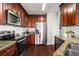 Well-equipped kitchen with stainless steel appliances, granite countertops, and dark wood cabinets at 3334 Peachtree Ne Rd # 1609, Atlanta, GA 30326