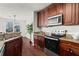 Gourmet kitchen with dark wood cabinetry, granite counters, and stainless steel appliances at 3334 Peachtree Ne Rd # 1609, Atlanta, GA 30326