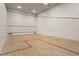 Spacious squash court with hardwood floors and white walls, ready for a competitive game at 3334 Peachtree Ne Rd # 1609, Atlanta, GA 30326