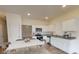 Modern kitchen with stainless steel appliances, granite countertops, and an adjacent dining area with stylish table at 5002 Elowen Ln, Douglasville, GA 30135