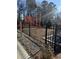 Community playground with a sturdy black fence and colorful play structures, perfect for Gathering activities at 5002 Elowen Ln, Douglasville, GA 30135