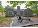 Backyard with a fire pit, perfect for entertaining, complemented by a well-maintained lawn and mature trees at 620 Alcovy Springs Dr, Lawrenceville, GA 30045