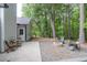 Serene backyard featuring a stone fire pit and patio, surrounded by lush greenery at 620 Alcovy Springs Dr, Lawrenceville, GA 30045