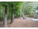 Expansive backyard featuring a fire pit area, offering a peaceful retreat surrounded by lush trees and greenery at 620 Alcovy Springs Dr, Lawrenceville, GA 30045