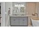Stylish bathroom showcasing double vanity sinks and a soaking tub with elegant finishes at 620 Alcovy Springs Dr, Lawrenceville, GA 30045
