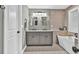 Stylish bathroom showcasing double vanity sinks and a soaking tub with elegant finishes at 620 Alcovy Springs Dr, Lawrenceville, GA 30045
