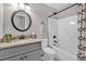Well-lit bathroom featuring a granite-topped vanity and a bathtub with a shower, complemented by stylish fixtures at 620 Alcovy Springs Dr, Lawrenceville, GA 30045