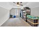 Well-lit bonus room with neutral carpet, ceiling fan, and ample storage shelves, perfect for flexible living at 620 Alcovy Springs Dr, Lawrenceville, GA 30045