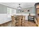 Inviting dining area with modern light fixture, wainscoting detail, and wood-look floors at 620 Alcovy Springs Dr, Lawrenceville, GA 30045