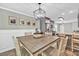 Open dining area with modern light fixture, views to kitchen, and wood-look flooring at 620 Alcovy Springs Dr, Lawrenceville, GA 30045