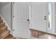 Bright entryway featuring hardwood floors, a white front door with sidelights, and an open view into the home at 620 Alcovy Springs Dr, Lawrenceville, GA 30045