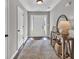 Bright entryway with wood floors, neutral walls, decorative table, and view of front door at 620 Alcovy Springs Dr, Lawrenceville, GA 30045