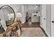 Stylish entryway featuring wood floors, a decorative mirror, and an open view to the living area at 620 Alcovy Springs Dr, Lawrenceville, GA 30045