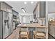 Modern kitchen with granite countertops, stainless steel appliances, and barstool seating at 620 Alcovy Springs Dr, Lawrenceville, GA 30045