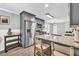 Charming kitchen with gray cabinets, stainless steel appliances, and a granite-topped breakfast bar at 620 Alcovy Springs Dr, Lawrenceville, GA 30045