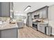 Well-lit kitchen with granite countertops, stainless steel appliances, and wood-look flooring at 620 Alcovy Springs Dr, Lawrenceville, GA 30045