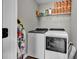 Efficient laundry room featuring a modern washer and dryer set, with shelving for storage and easy access at 620 Alcovy Springs Dr, Lawrenceville, GA 30045
