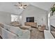 Bright and airy living room featuring neutral paint colors, fireplace, ceiling fan, and comfortable seating at 620 Alcovy Springs Dr, Lawrenceville, GA 30045