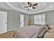 Serene primary bedroom featuring a tray ceiling, neutral palette, and ensuite access at 620 Alcovy Springs Dr, Lawrenceville, GA 30045