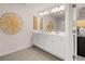Bright bathroom featuring double sinks, white cabinetry, and decorative wall accents at 1023 Merritt Dr # 100, Villa Rica, GA 30180