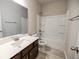 Bright bathroom featuring a shower-tub combination and a vanity with a large mirror at 2924 Weyhill Trl, Buford, GA 30519
